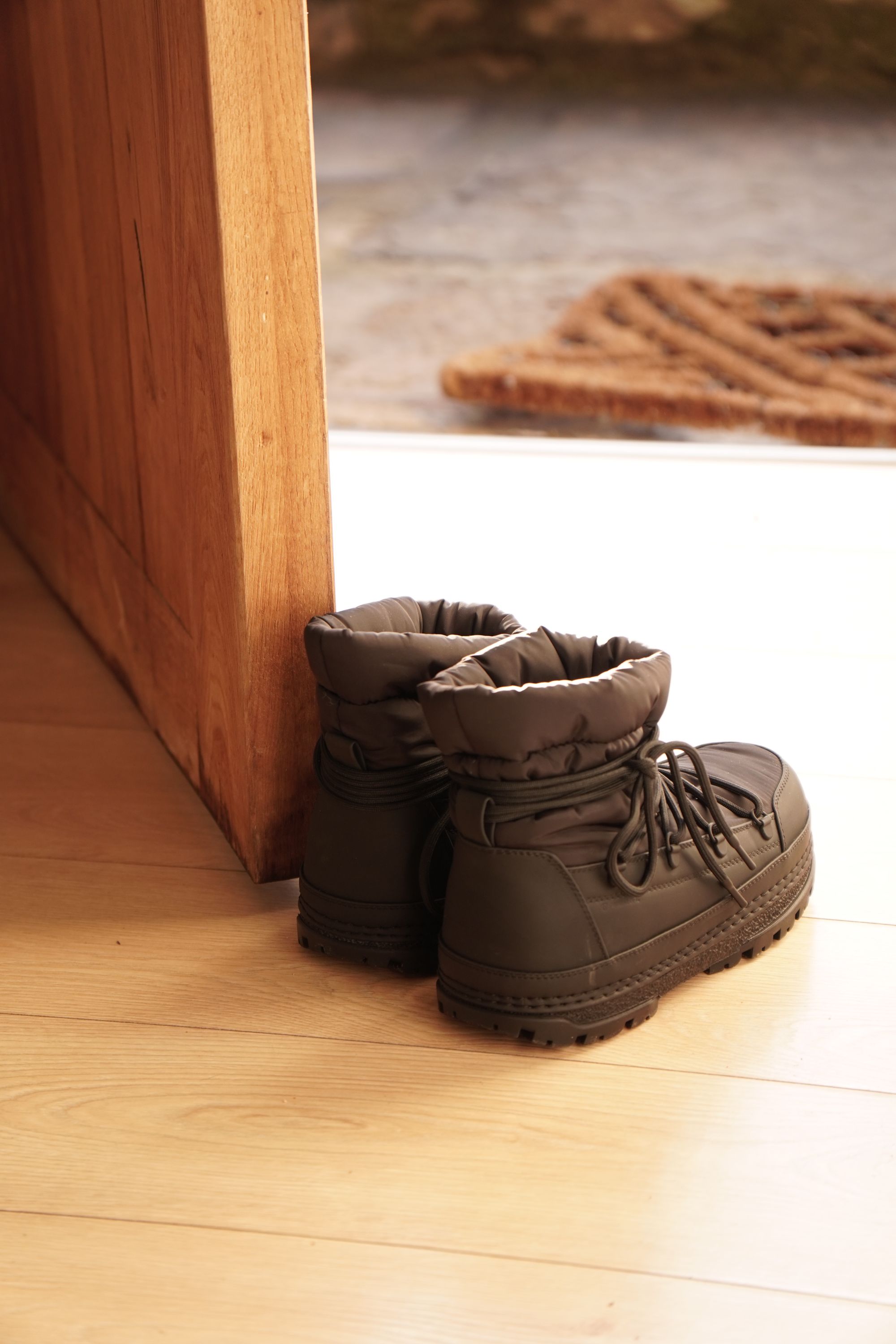 Illustrative photograph of boots near a doorway; no SOTHING product is depicted